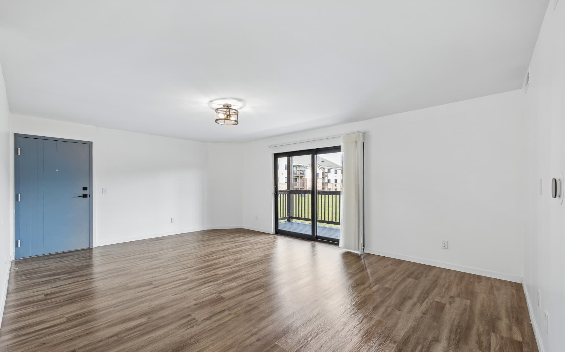 Spacious living room with sliding balcony doors