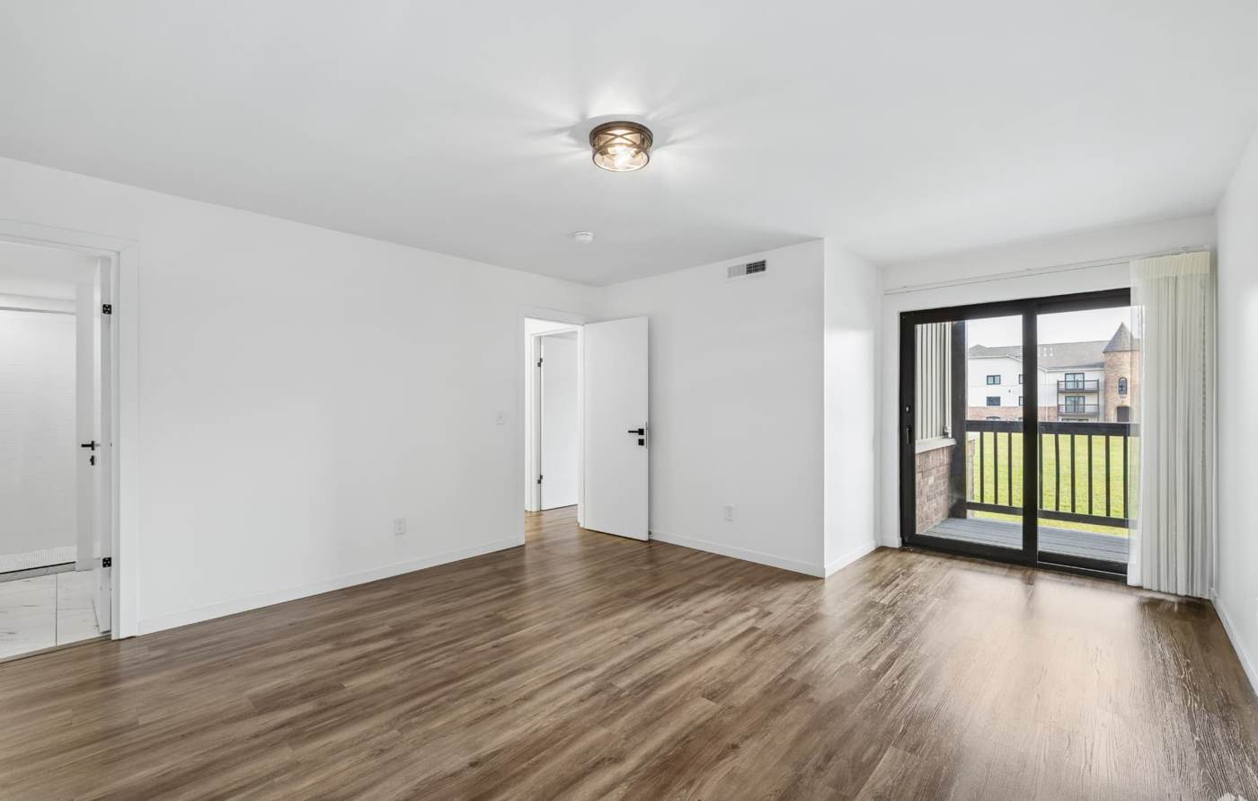 Bright living area with balcony overlooking the community